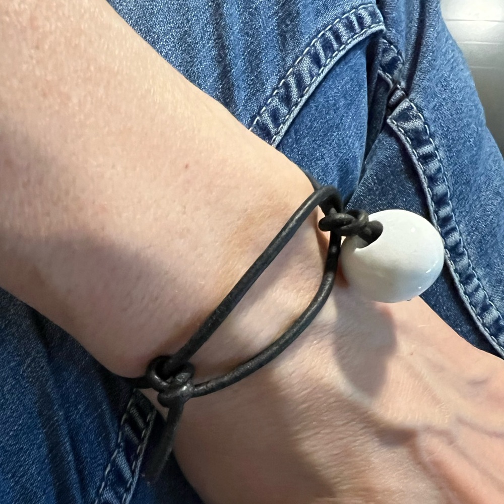 Simple adjustable bracelet-porcelain bead on leather
